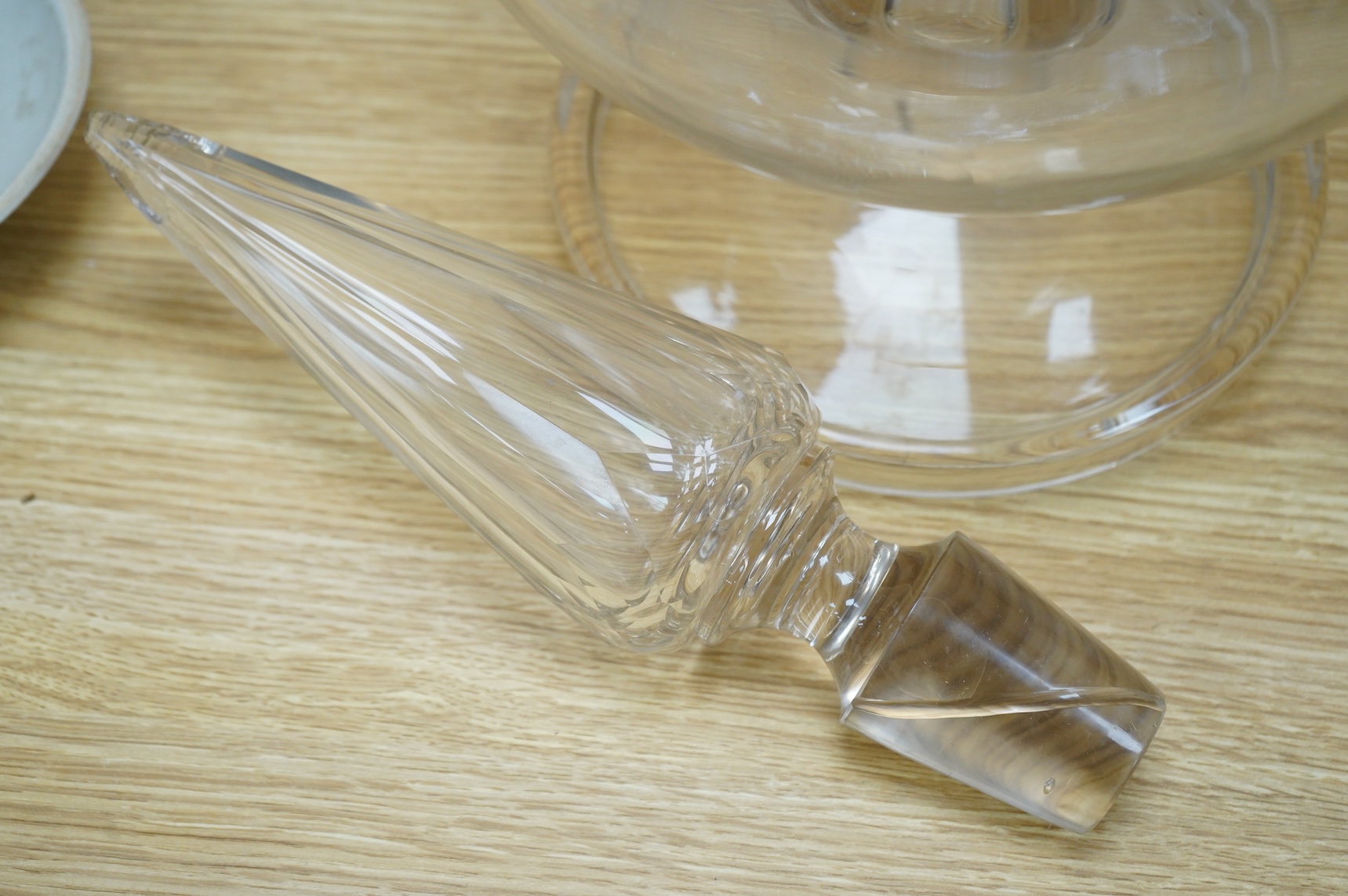 A pair of large clear glass chemist window display bottles and stoppers, one with chip, 90cm high